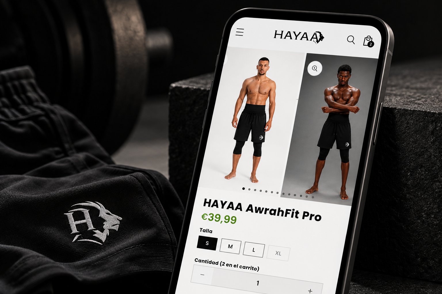 Ficha de producto de la tienda Shopify de HAYAAA en un móvil, junto a un pantalón corto negro con el logotipo bordado del león